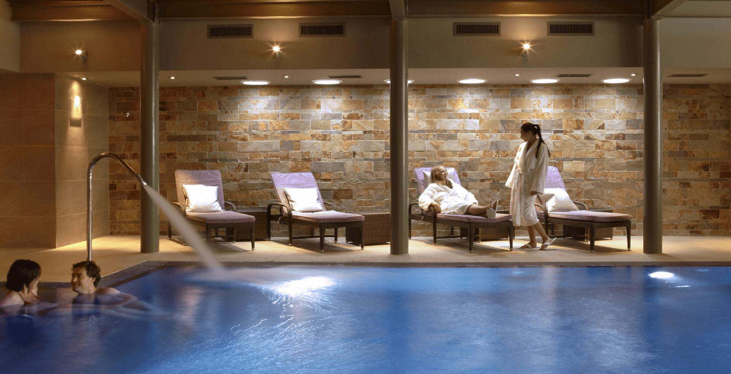 Couple relaxes by the pool in Elan Spa at Greenway - Christmas holiday ideas